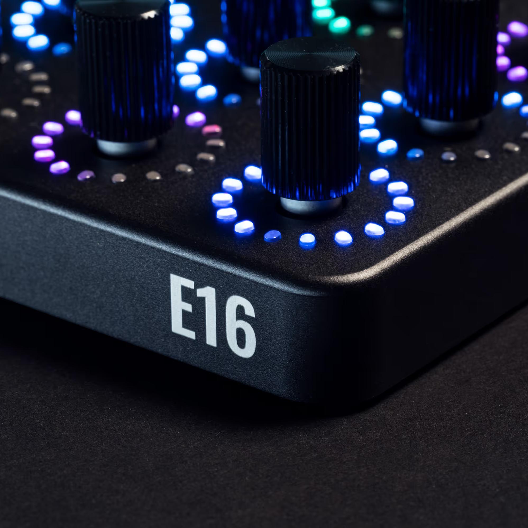 OXI Instruments E16 MIDI controller with multiple knobs and pads, shown in a corner view highlighting its compact design and controls.
