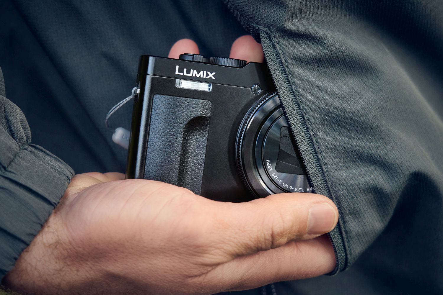 Panasonic Lumix TZ99 black compact video camera with lens and control buttons, ideal for travel and everyday recording.