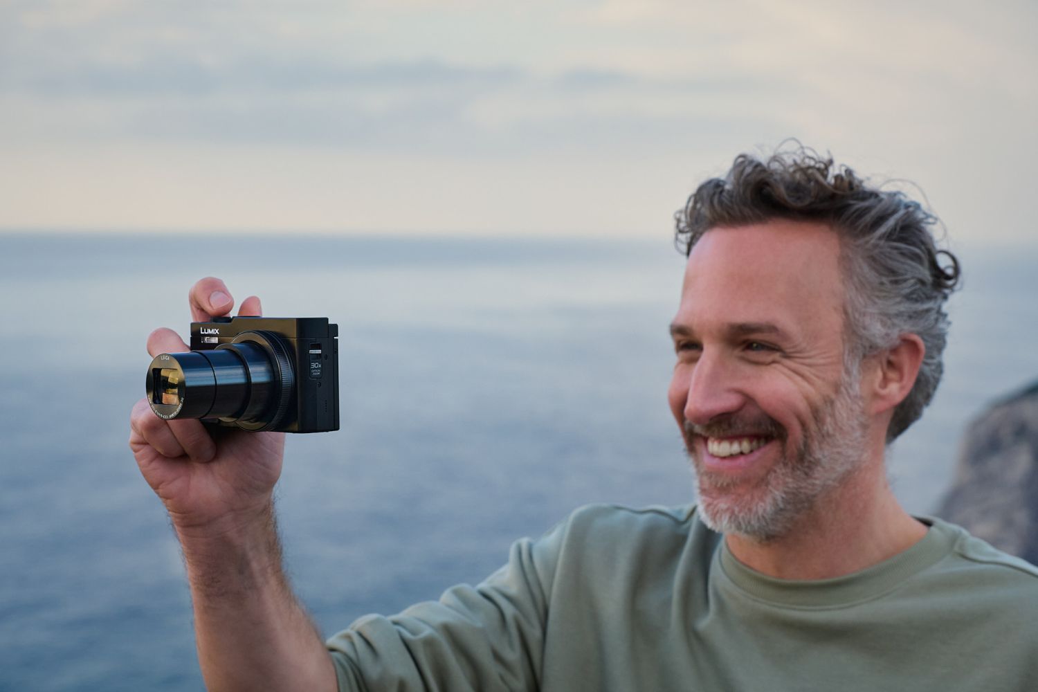 Black Panasonic Lumix TZ99 video camera with compact design and zoom lens, ideal for travel and high-quality video recording.