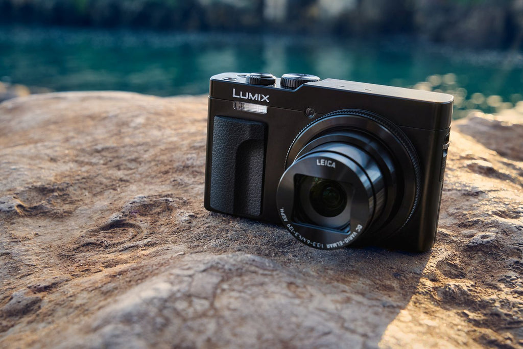 Black Panasonic Lumix TZ99 video camera with compact design and adjustable lens, suitable for travel and high-quality filming.
