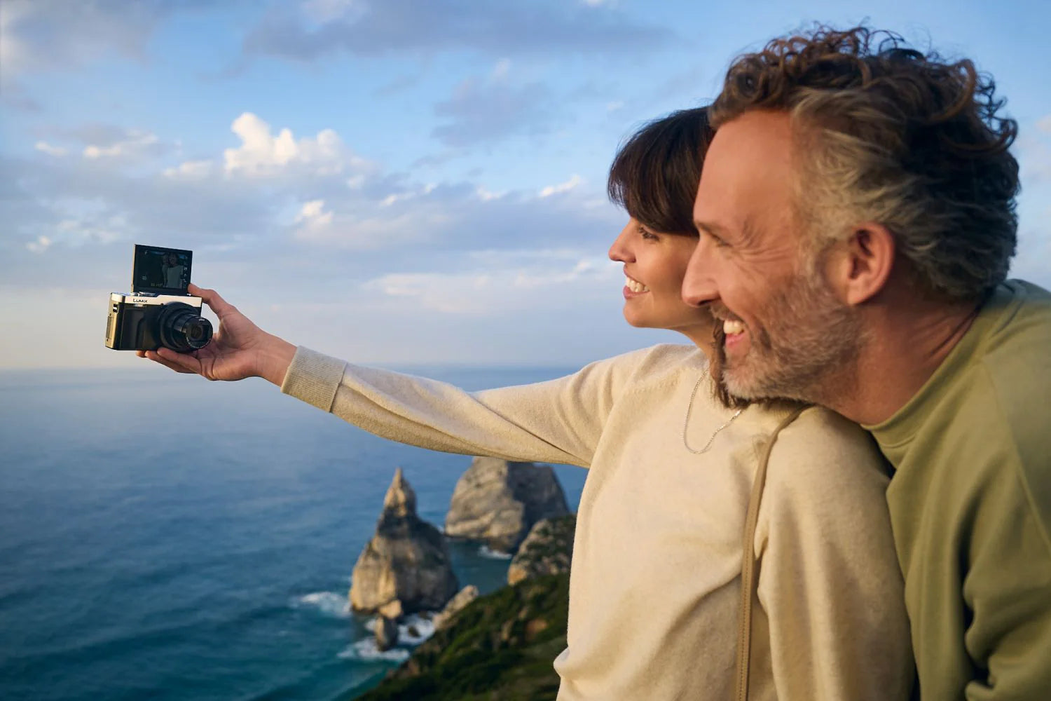 Panasonic Lumix TZ99 video camera in silver and black with a compact design and zoom lens for high-quality video recording.