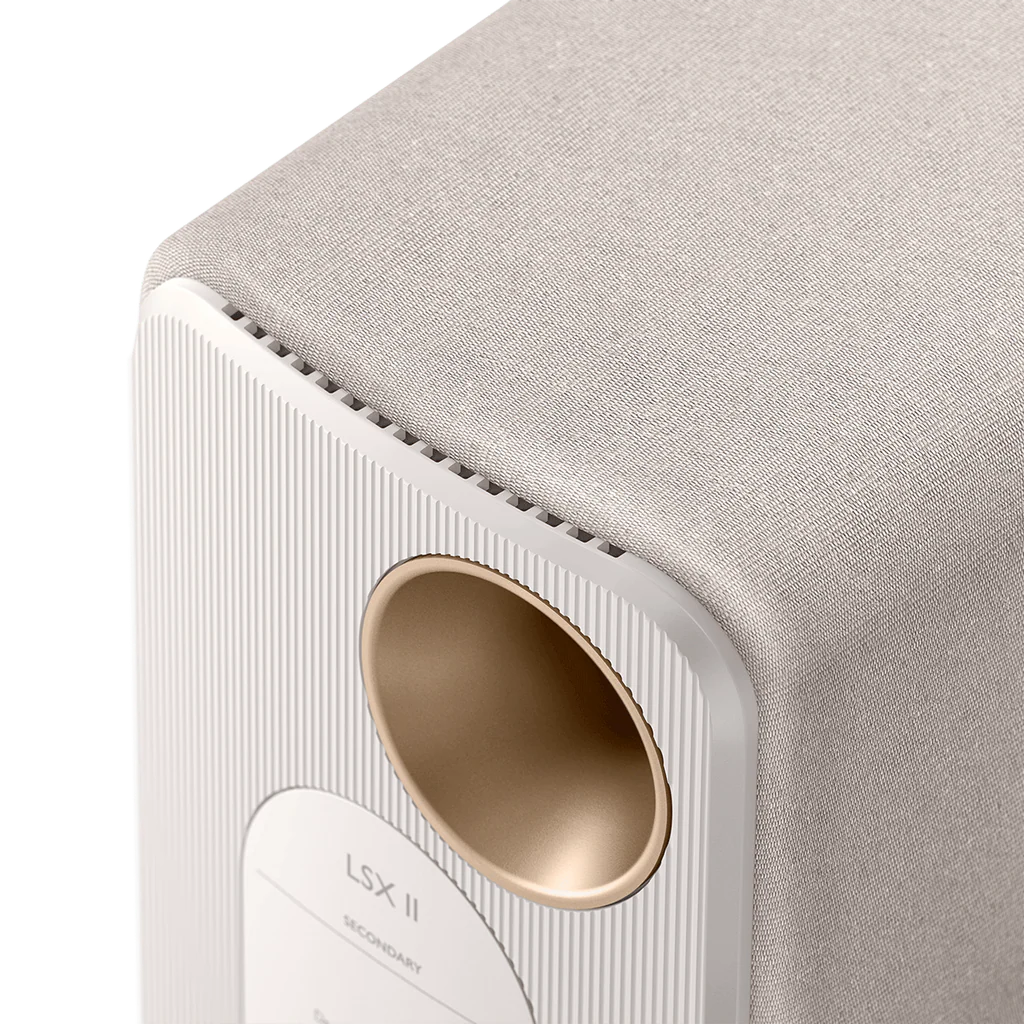 KEF LSX II active bookshelf speakers with sleek design and grille covering, showing their modern compact speaker setup.