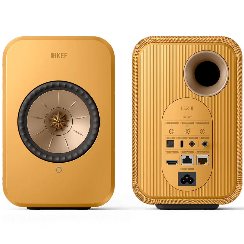 KEF LSX II active bookshelf speakers with sleek design, featuring fabric covers and wooden base for high-quality audio.