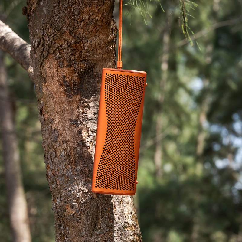 KEF Muo portable speaker in a lifestyle setting, showcasing its sleek design and compact size for high-quality sound.