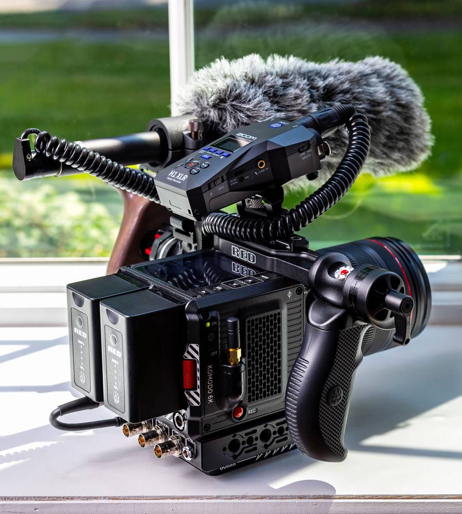 Zoom H1 XLR digital recorder with on-camera mounting, featuring a compact design and multiple input options for high-quality audio recording.