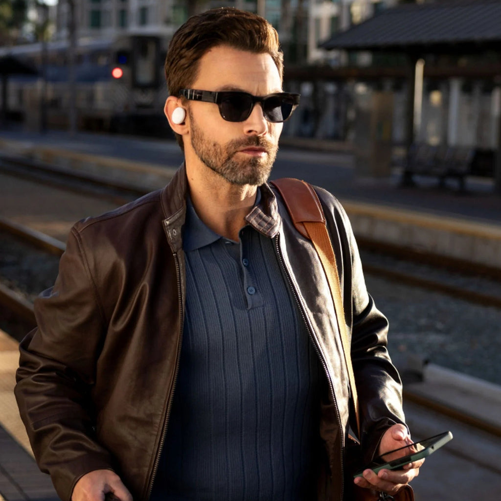 Denon PerL PRO wireless in-ear headphones with sleek black design and secure fit, shown in a lifestyle setting.