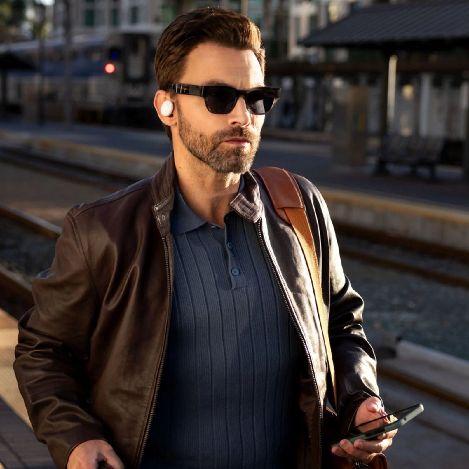Denon PerL PRO wireless in-ear headphones with sleek black design and secure fit, shown in a lifestyle setting.