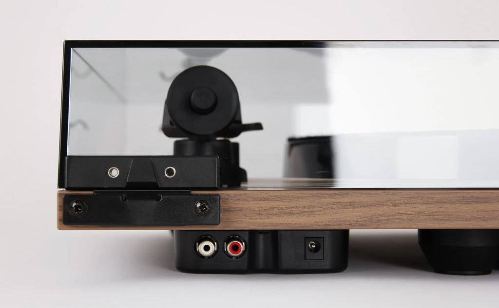 Rega Planar 1 Plus turntable with walnut finish, showing rear view and built-in phonostage in a detailed product image.