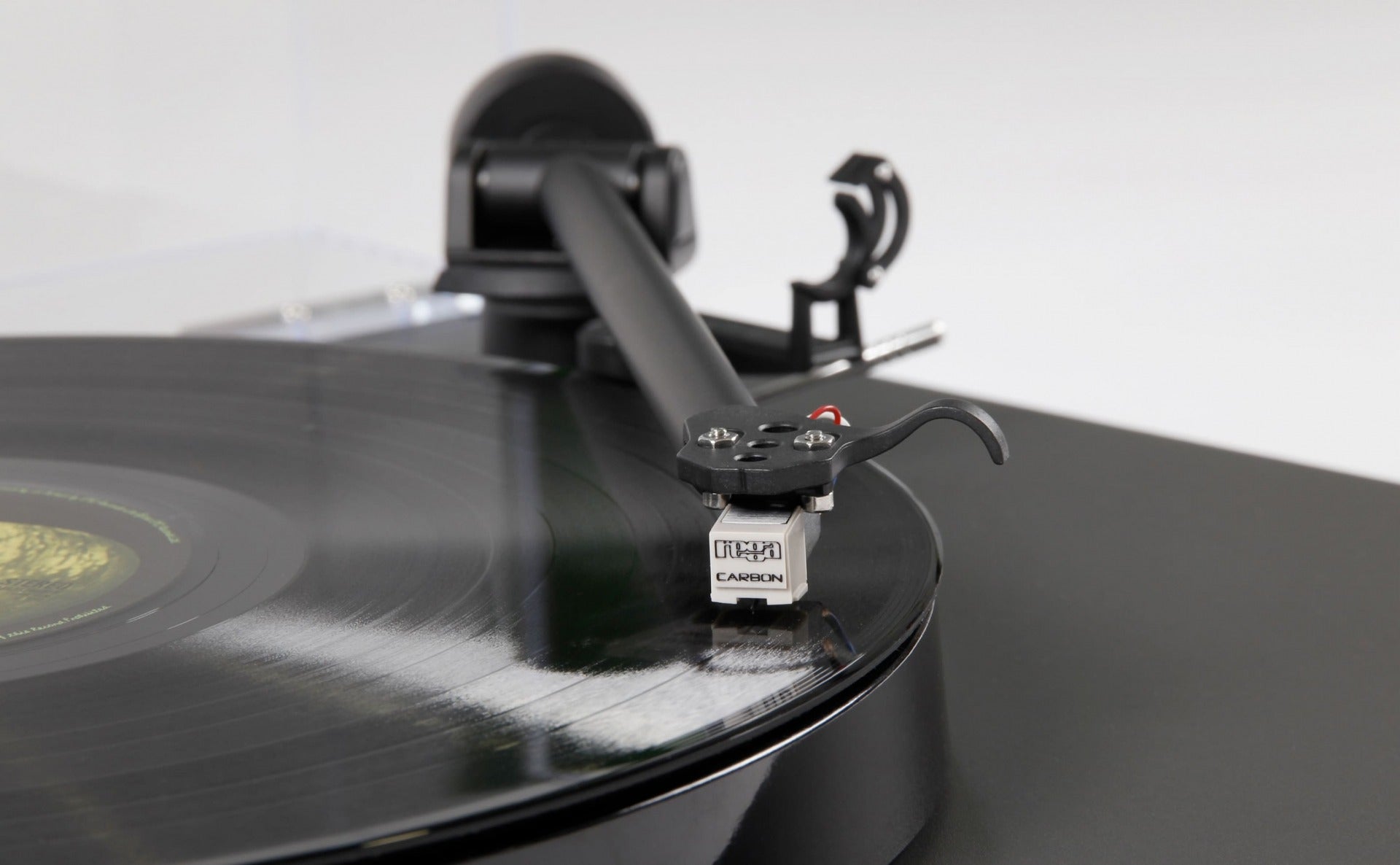 Rega Planar 1 turntable with matte finish, featuring a sleek design and tonearm, showcasing high-quality audio equipment.