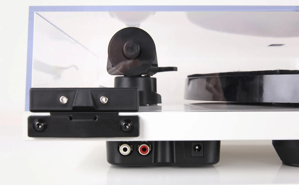 Rega Planar 1 Plus turntable with sleek wooden plinth and tonearm, showcasing modern audio equipment for vinyl playback.