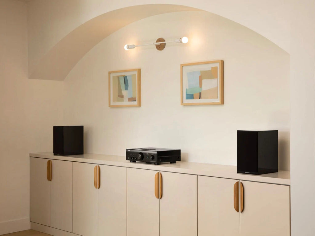 Denon PMA-900HNE stereo amplifier showing front and side angles with control knobs and display panel.