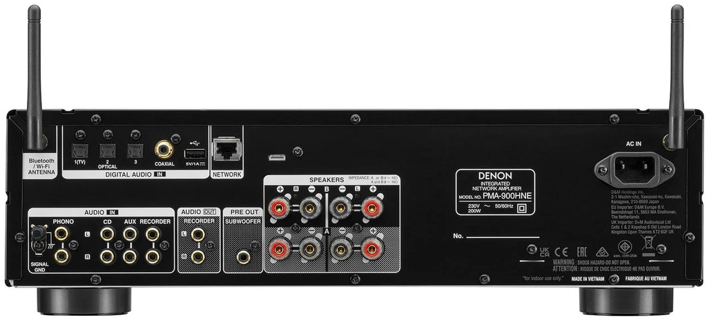 Denon PMA-900HNE stereo amplifier with multiple input options and sleek black finish, shown on a modern home audio setup.