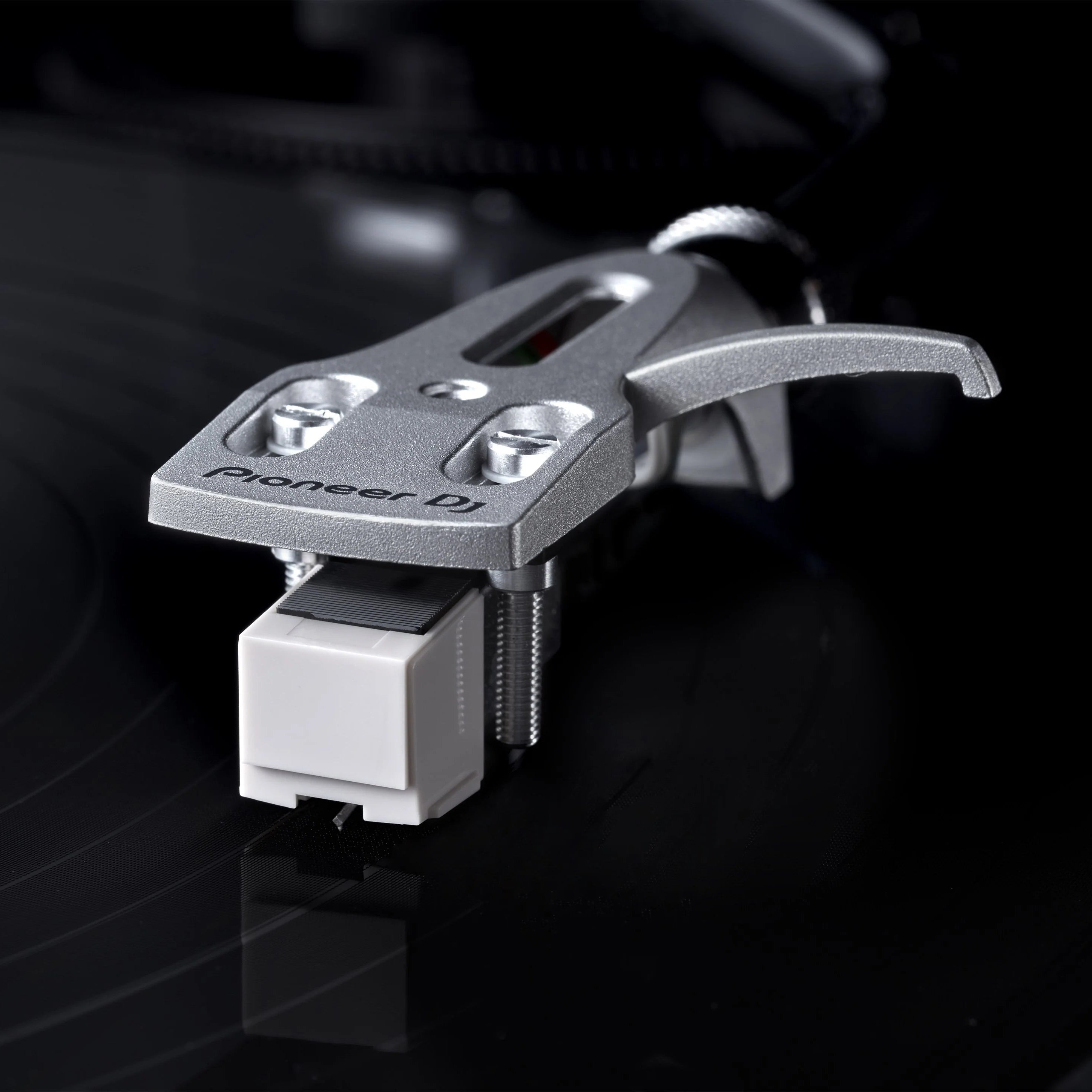 Pioneer DJ PN-X05 replaceable stylus for PLX-500 turntable, shown in a lifestyle setting with turntable and vinyl records