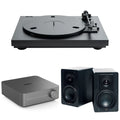 Pro-Ject Automat A1.2 turntable with integrated amplifier and passive speakers in a home audio setup.