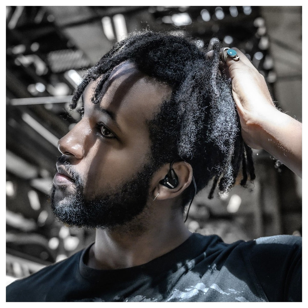 Shure SE215 wired in-ear headphones with black ear tips and inline remote, designed for high-quality sound and comfort.