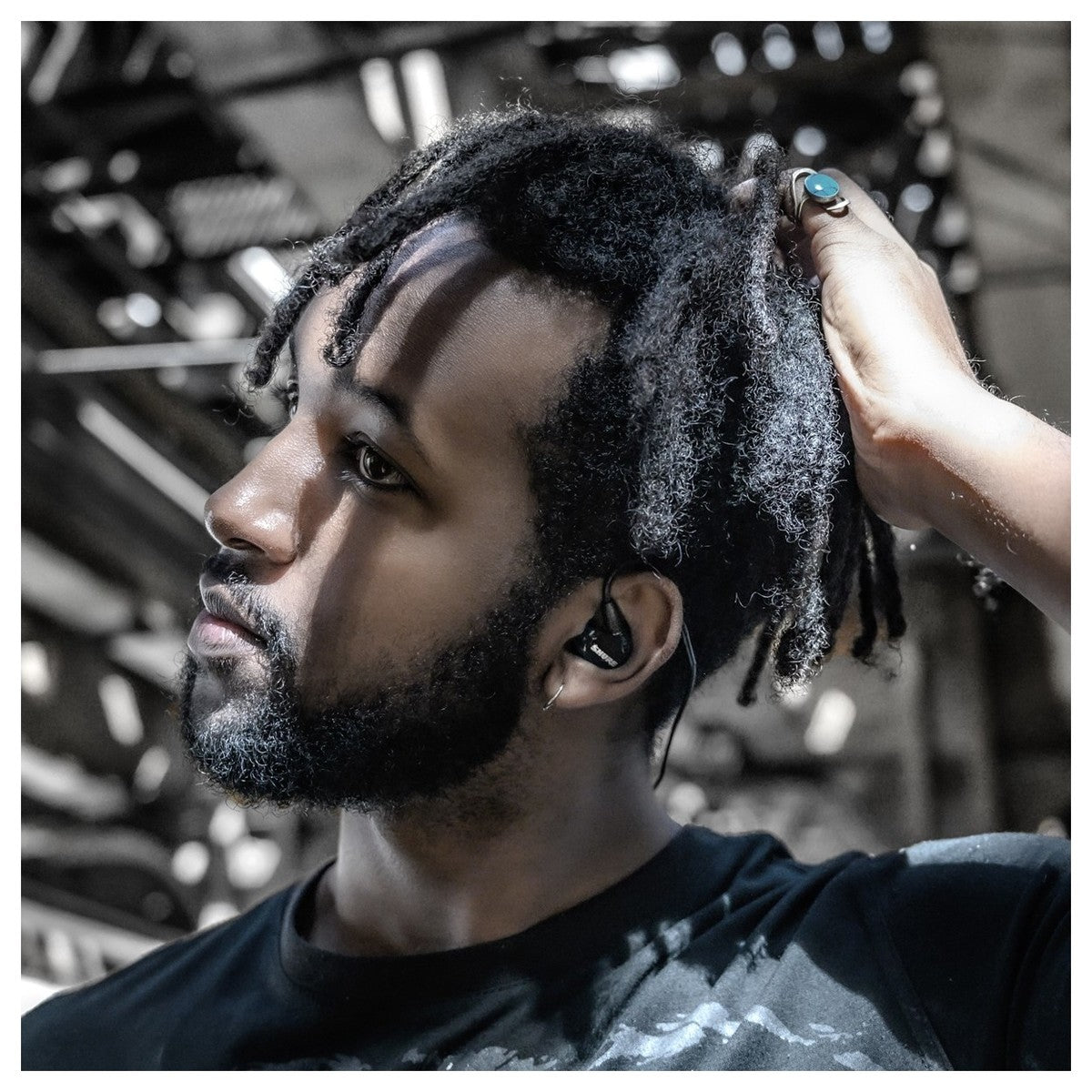 Shure SE215 wired in-ear headphones with black ear tips and inline remote, designed for high-quality sound and comfort.