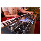 Arturia PolyBrute synthesizer with a sleek control panel and colorful LED display, showcasing its professional music production features.