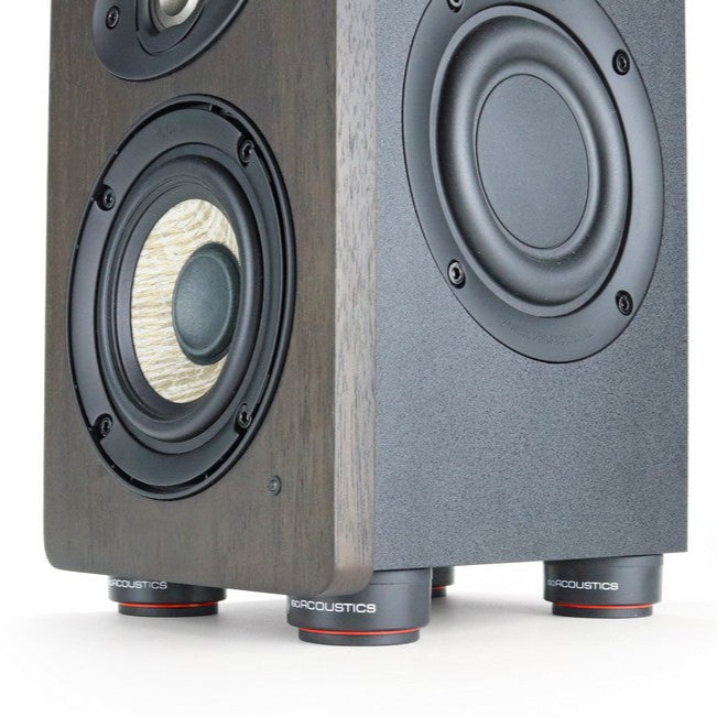 IsoAcoustics ISO-Puck Mini studio monitor stand puck placed on a surface, designed to improve sound isolation and reduce vibrations.