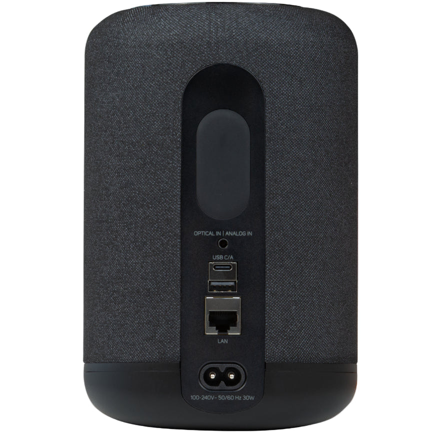 Black Bluesound Pulse Flex wireless speaker viewed from the rear with shadow, showcasing its compact design and modern build.