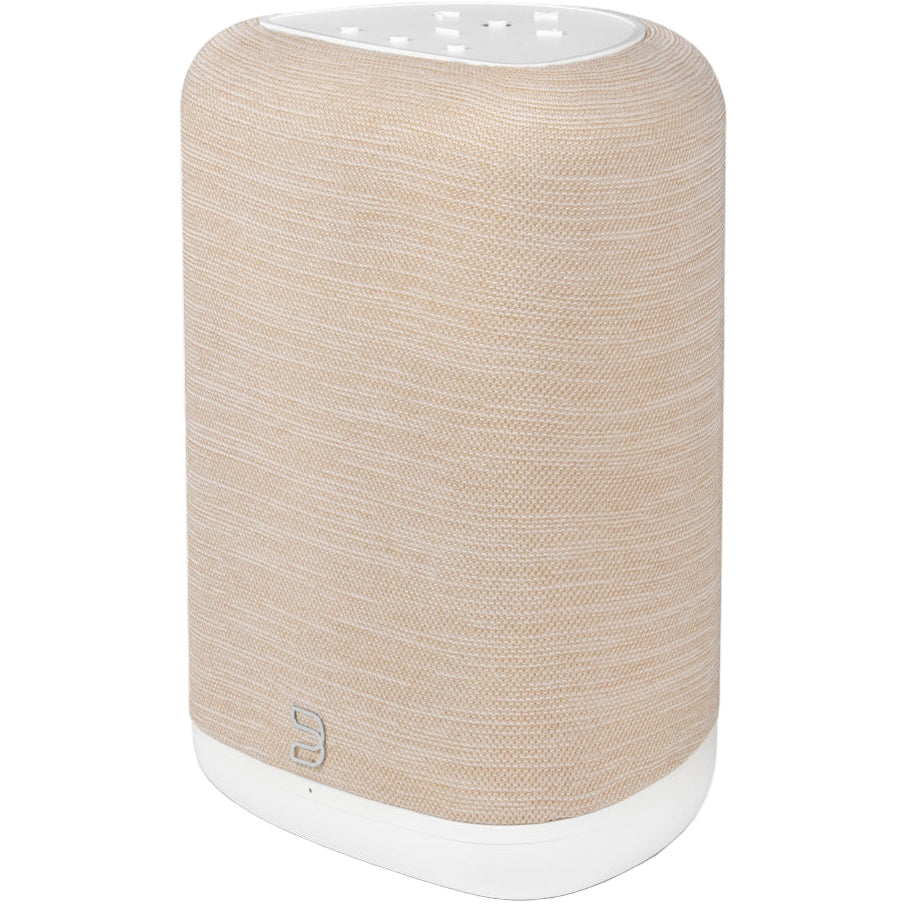 Bluesound Pulse Flex wireless speaker in tan color, shown from the right above with shadow, highlighting compact design and fabric grille.