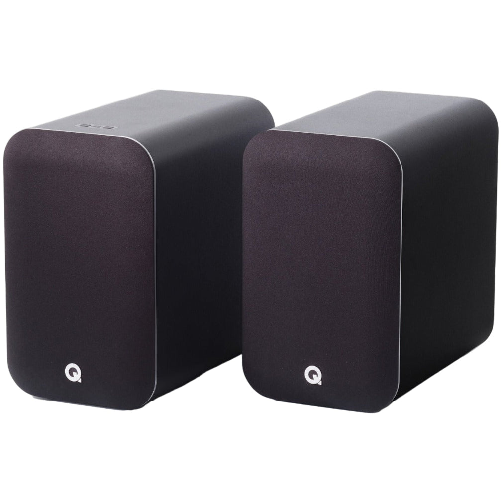 Q Acoustics M20 HD wireless speakers shown in a modern home setting, highlighting sleek design and compact size.