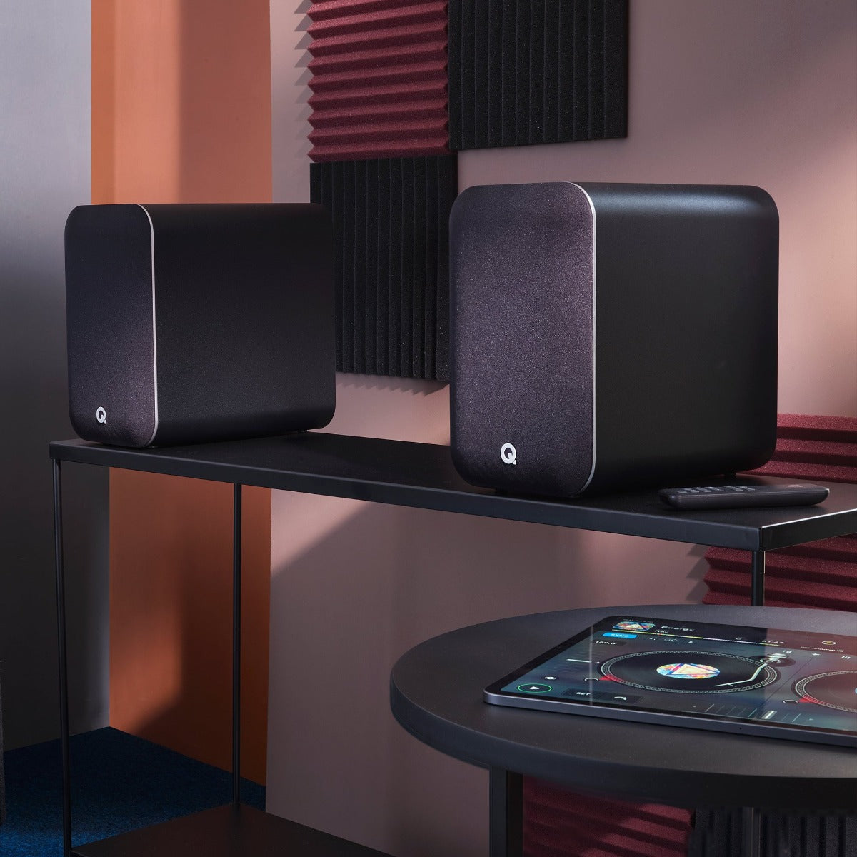 Q Acoustics M20 HD wireless speakers shown with sleek black design, compact size, and modern speaker grille.