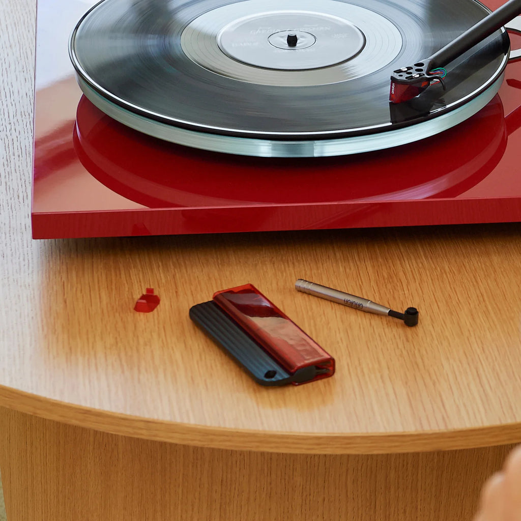 Ortofon record brush for cleaning vinyl records, with soft bristles to remove dust and static for better sound quality.