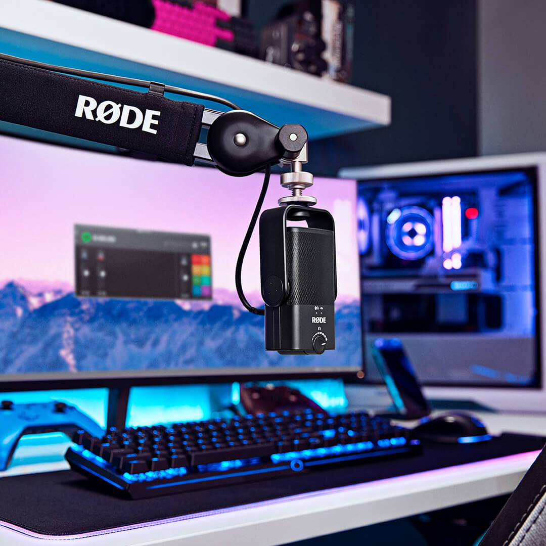Rode NT-USB Mini USB microphone with adjustable stand and pop filter on a desk, ready for high-quality audio recording.