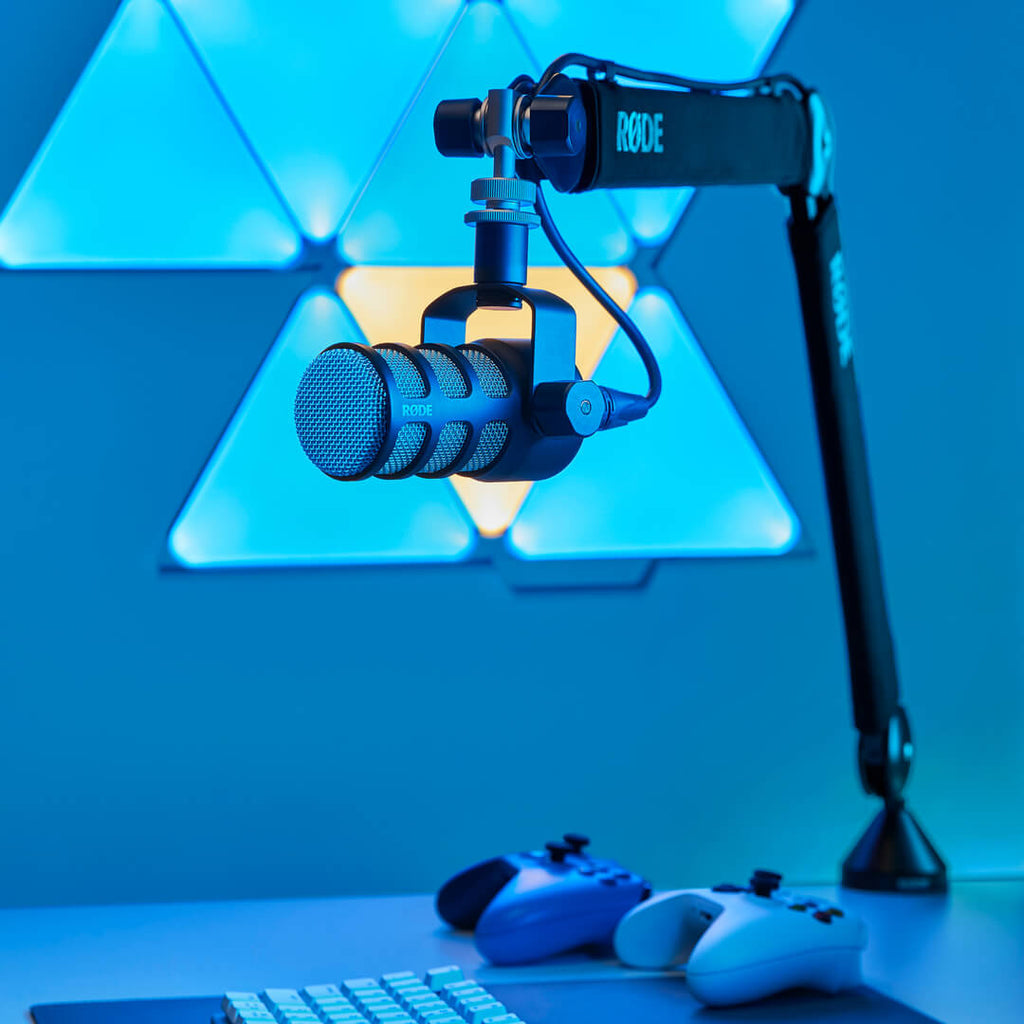 Rode PSA1+ broadcast microphone arm mounted on a desk, adjustable with a professional, sleek design for studio or podcast use.