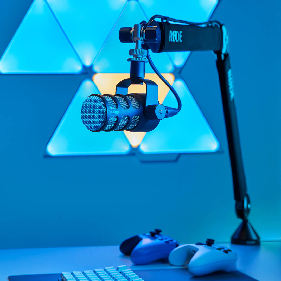 Rode PSA1+ broadcast microphone arm mounted on a desk, adjustable with a professional, sleek design for studio or podcast use.