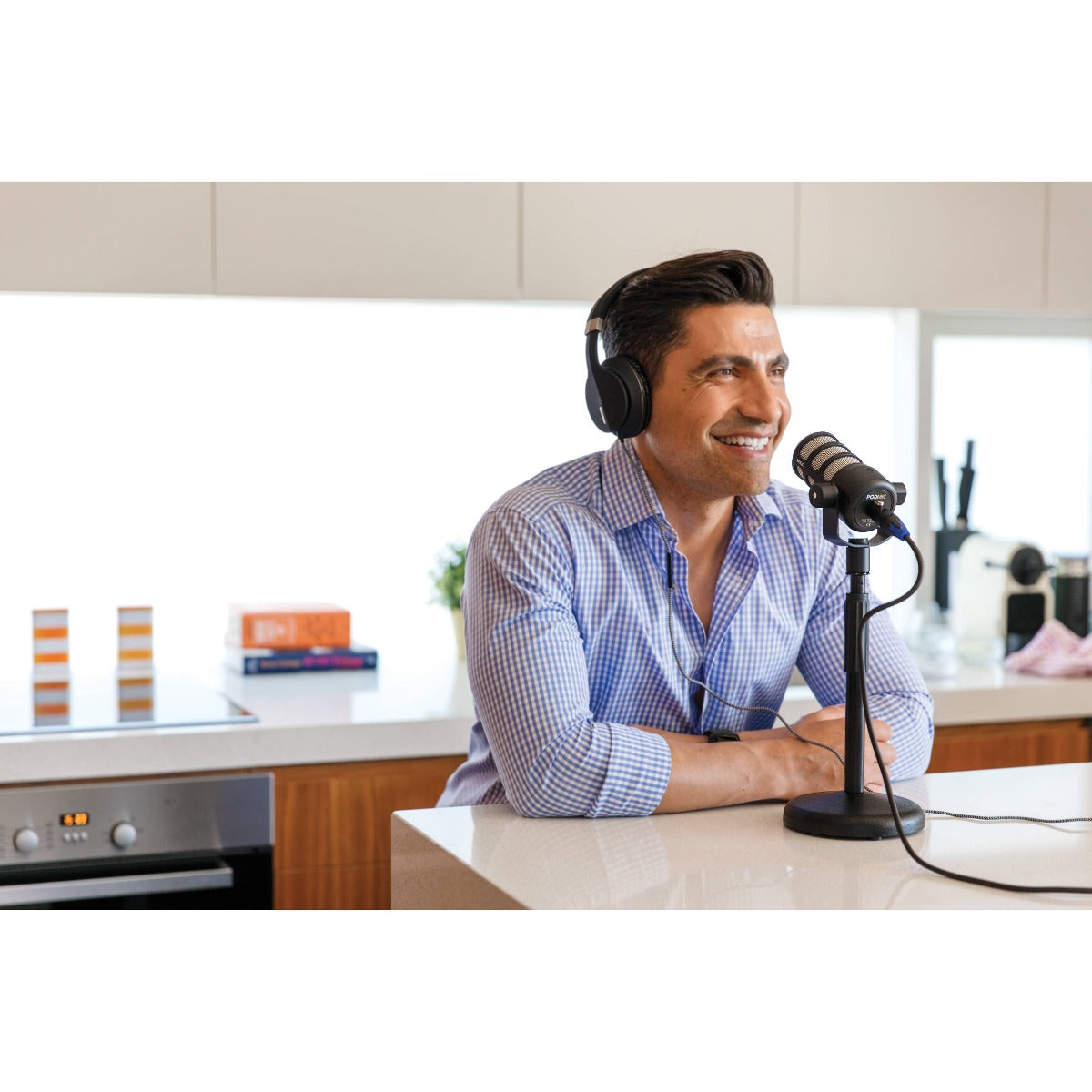 Rode PodMic dynamic microphone with a metal grille and black body, ideal for podcasting and broadcasting.