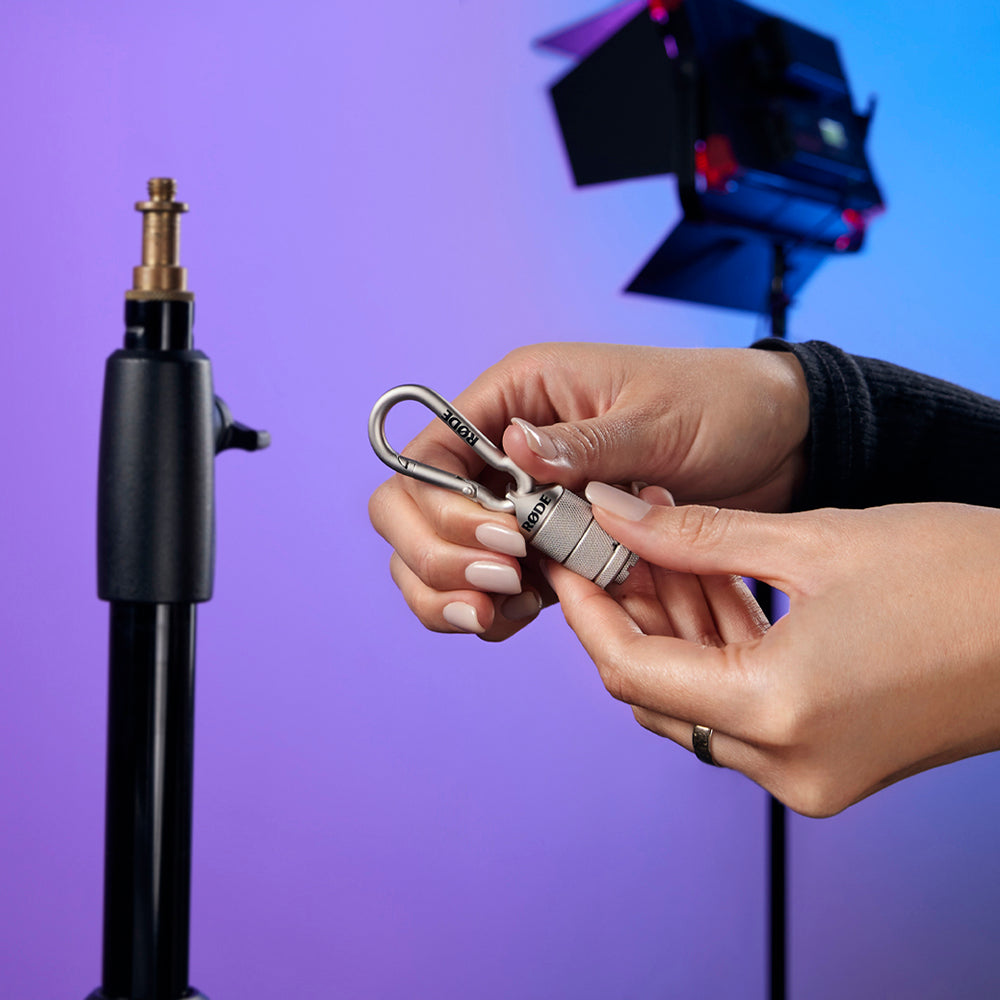 Rode Thread Adaptor being unscrewed in studio, used for microphone shock mounts and adapters by Rode.