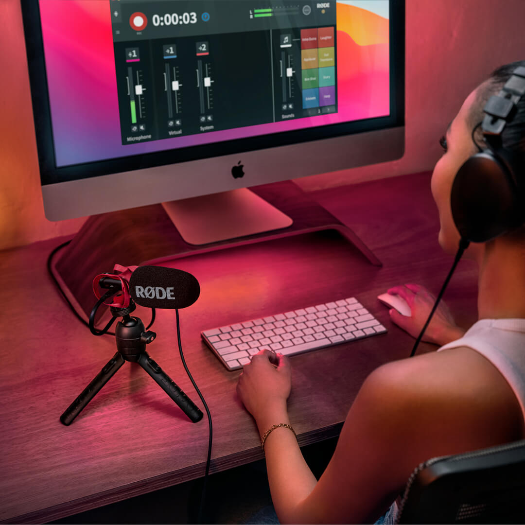 Rode VideoMic Go II shotgun microphone mounted on a desk setup with RGB lighting, used by a girl during a video call.