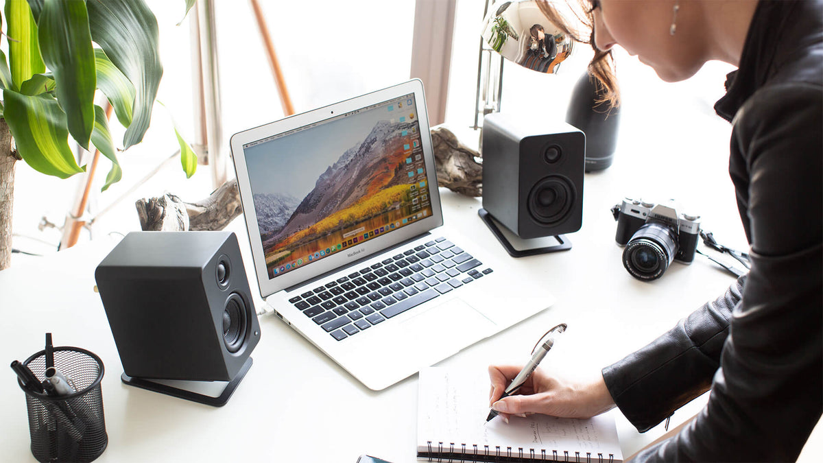 Kanto Audio S2 desktop speaker stands supporting small to medium speakers on a modern desk setup.