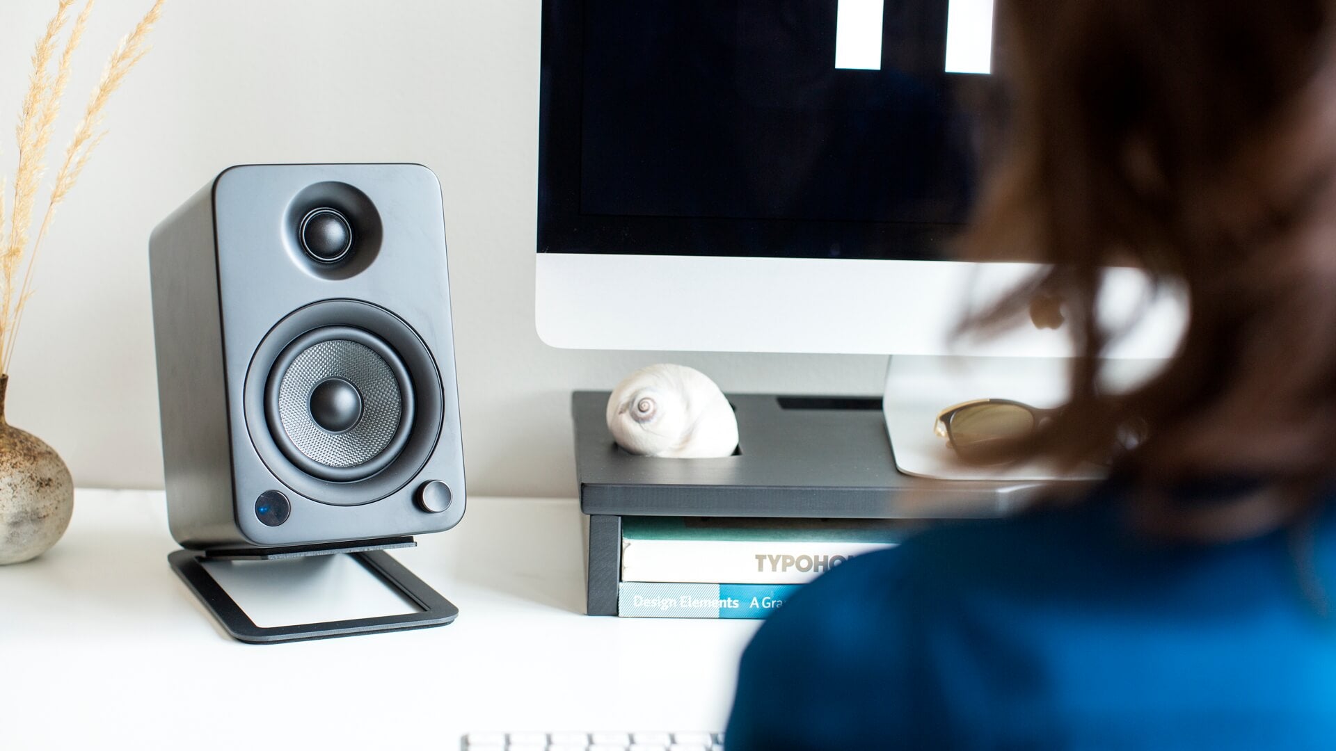 Black Kanto Audio S4 desktop speaker stands shown with sleek, sturdy design for supporting bookshelf speakers on a desk.