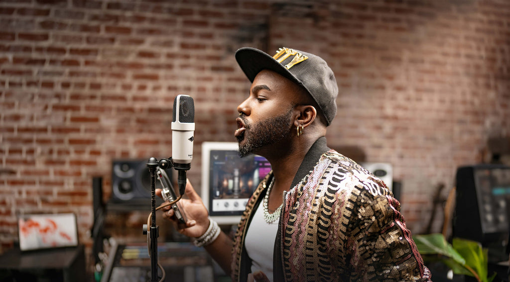 Universal Audio SC-1 condenser microphone shown with its sleek black body and gold grille, ideal for studio recording.