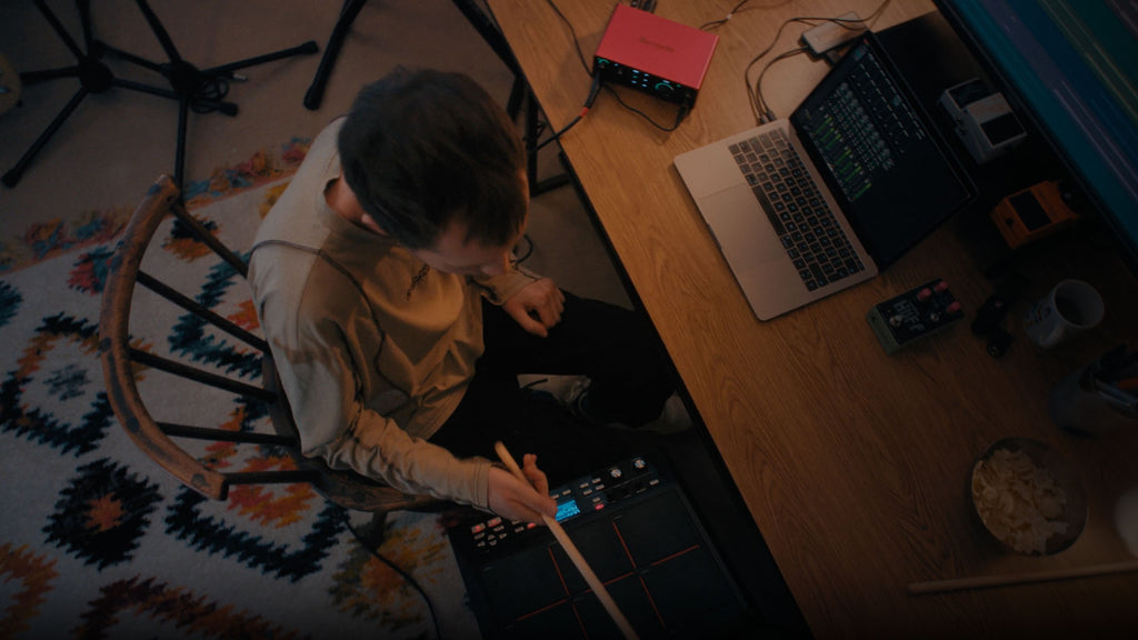 Focusrite Scarlett Solo 4th Gen audio interface with connected cables and setup, showcasing its portable design and controls.
