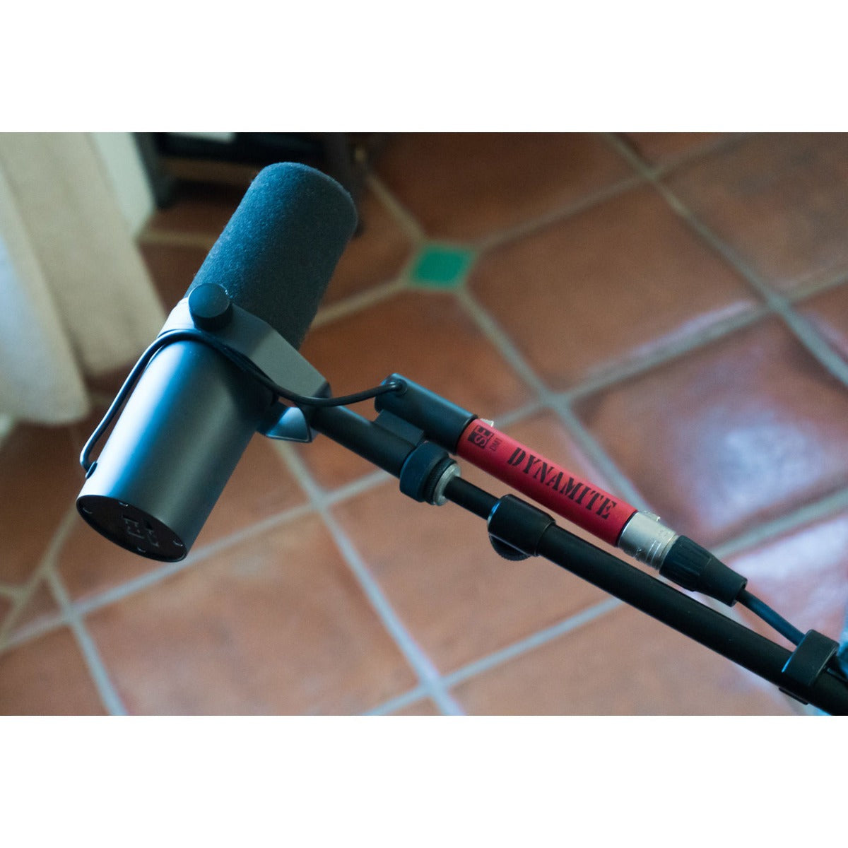 SE Electronics DM1 Dynamite microphone preamp with remote control and LED indicators on a professional audio setup.