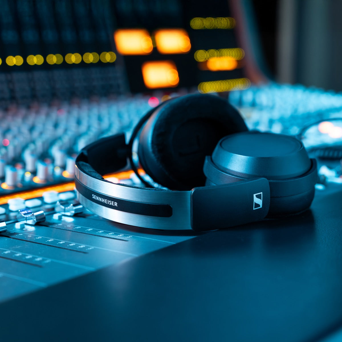 Sennheiser HD 480 Pro Plus studio headphones with large over-ear design and padded headband, resting on a table.