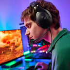 Gamer using the Sennheiser HD 500 BAM boom microphone at an RGB-lit desk