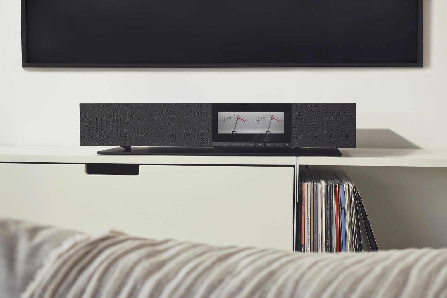 Cambridge Audio Evo One wireless speaker with sleek design and control buttons, set against a neutral background.