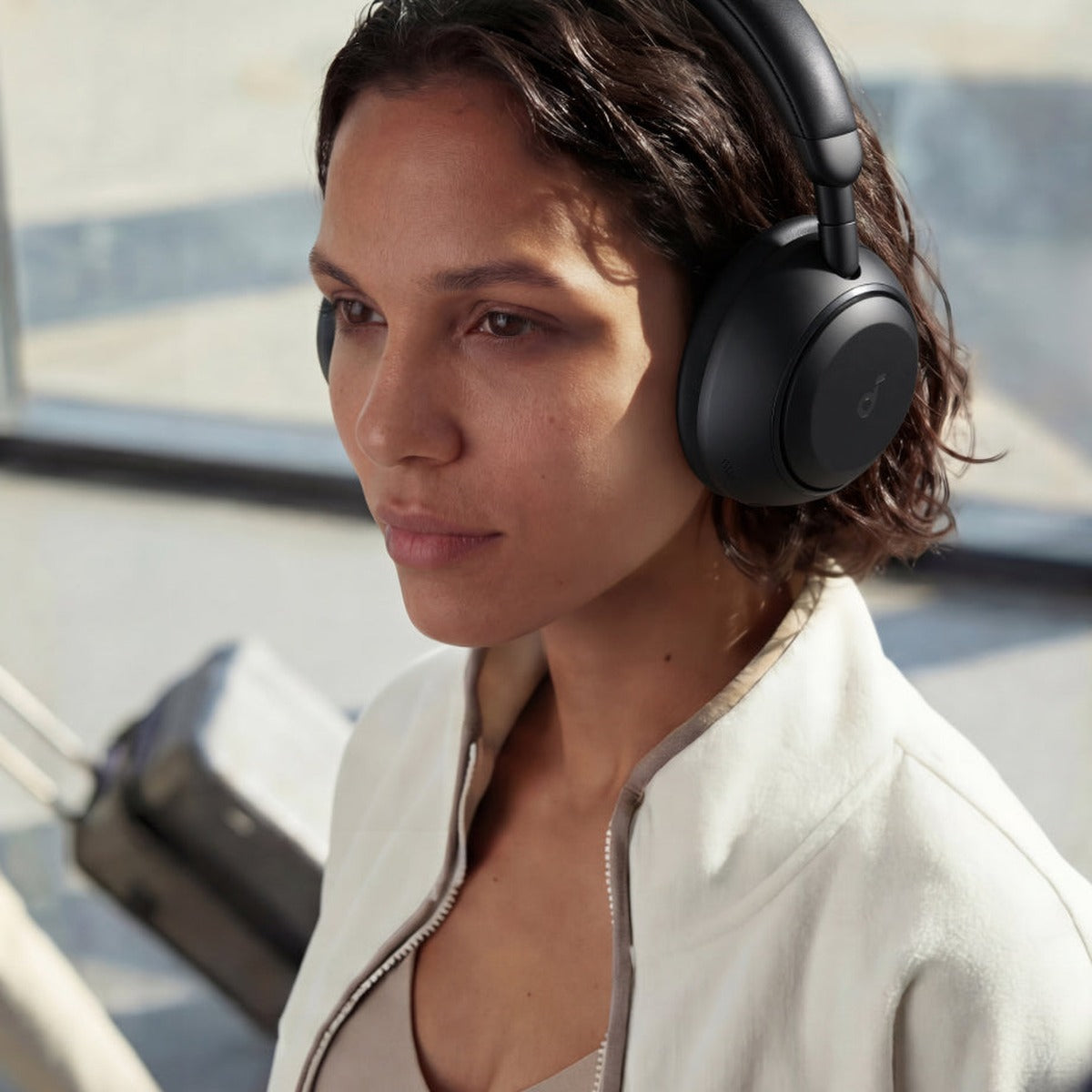 Person wearing Soundcore Space 2 wireless headphones in jet black, showcasing comfortable over-ear design and modern style.