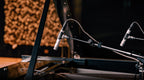 Universal Audio SP-1 condenser microphone with professional-grade design and adjustable stand, ideal for studio recording.