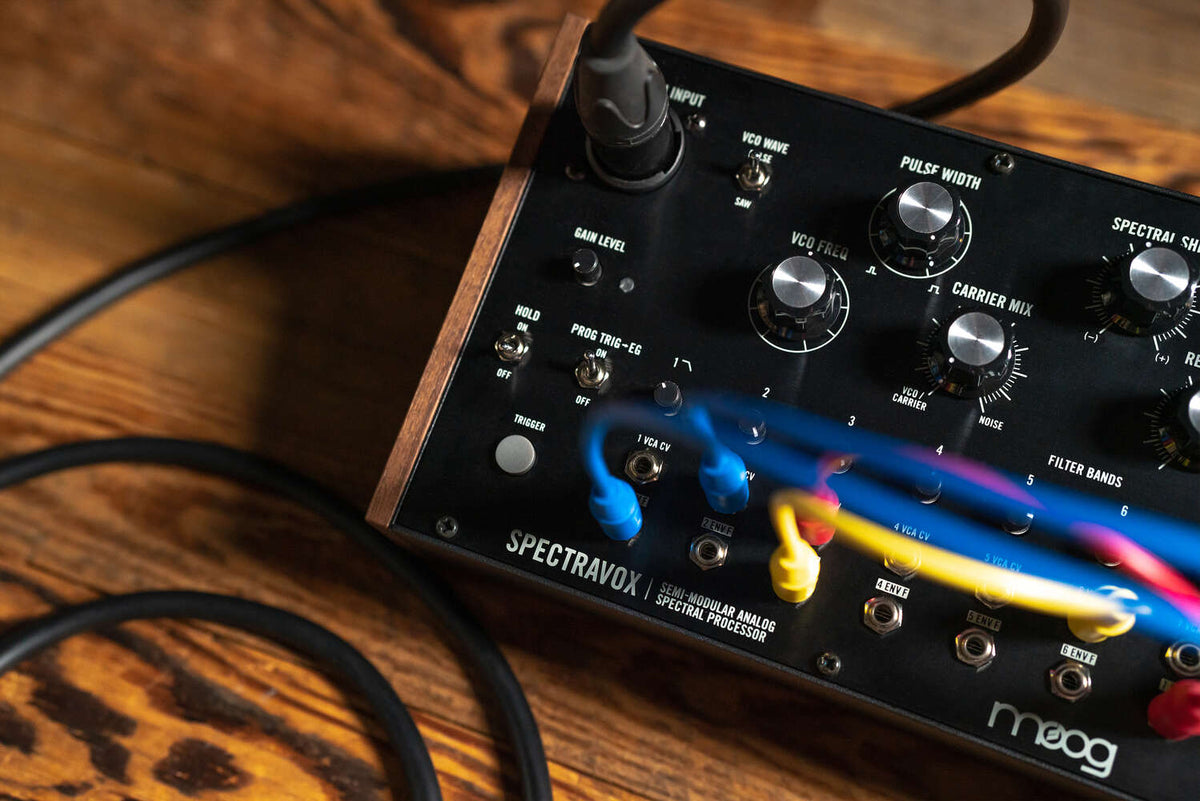Black Moog Spectravox synthesizer with control knobs and display, showcasing its vintage-inspired design and interface.