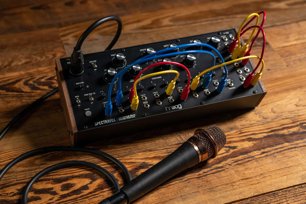 Black Moog Spectravox synthesizer with dials and controls, showcasing its vintage-inspired design and compact build.