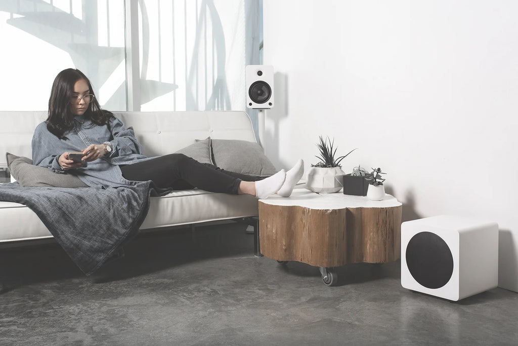 White Kanto Audio SUB8V subwoofer with sleek design, featuring a compact build and front-facing speaker grille.