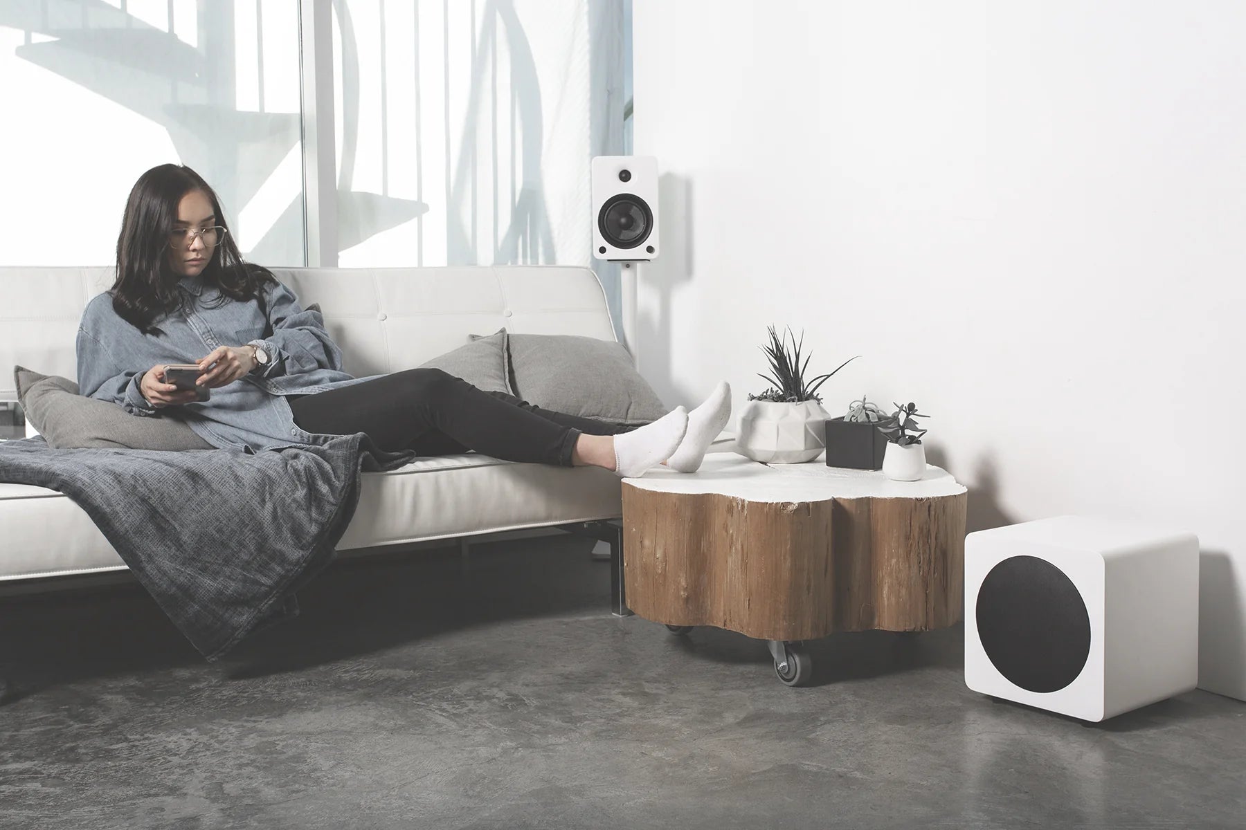 White Kanto Audio SUB8V subwoofer with sleek design, featuring a compact build and front-facing speaker grille.