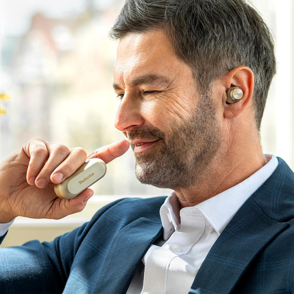 Technics EAH-AZ100 wireless in-ear headphones in sleek gold with ergonomic design and compact charging case.