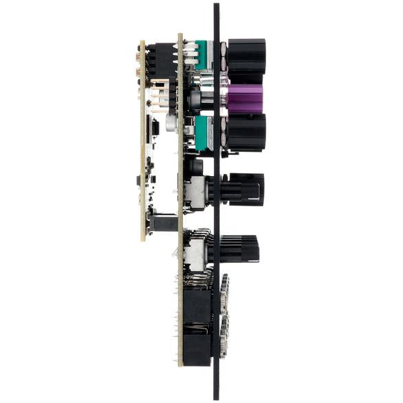 OXI Instruments Coral semi-modular synthesizer with colorful patch cables and control knobs, set on a studio surface.