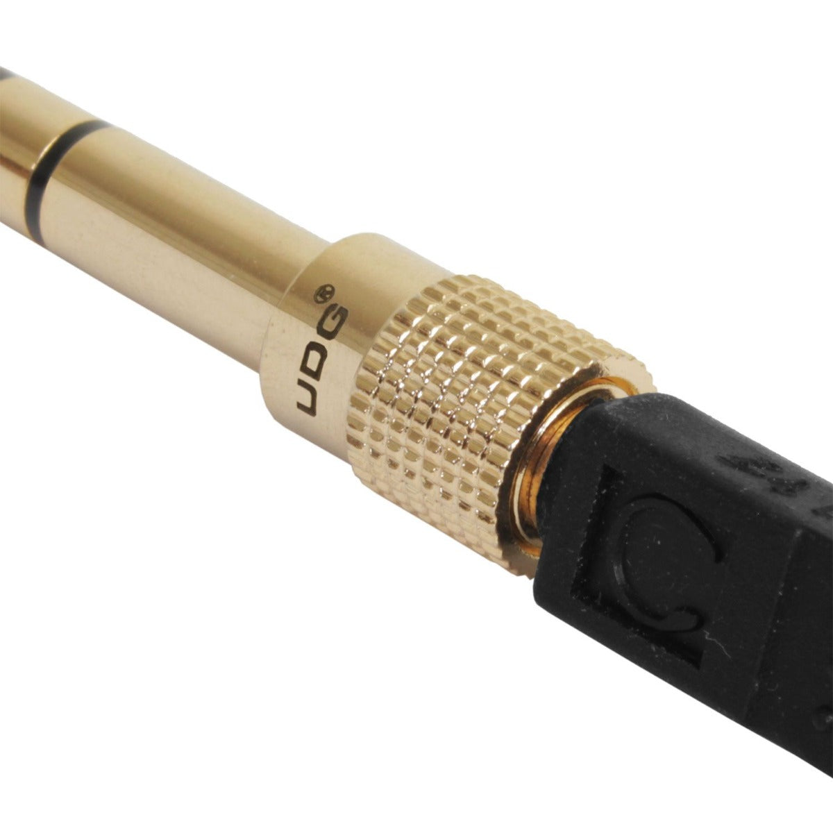 UDG Ultimate Headphone Jack Adapter Plug connected to audio device, compact U94002 headphone splitter for versatile audio use